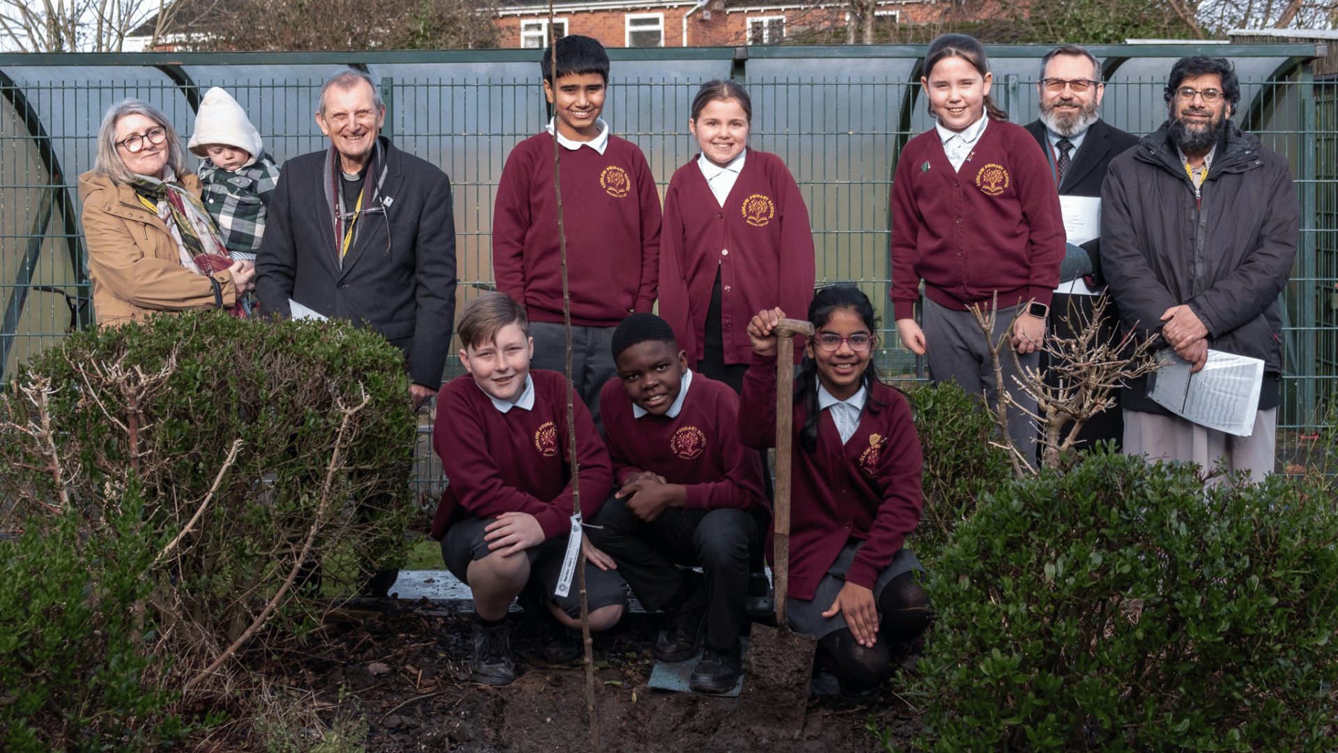 Ludlow primary school pupils with faith leaders planting cherry tree