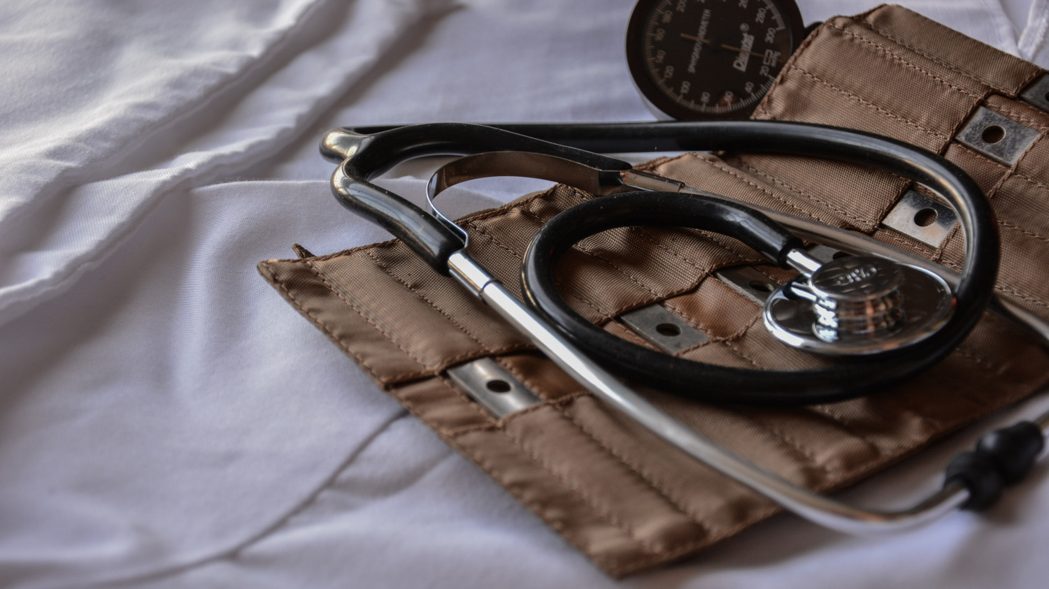 Image of a stethoscope on a hospital bed