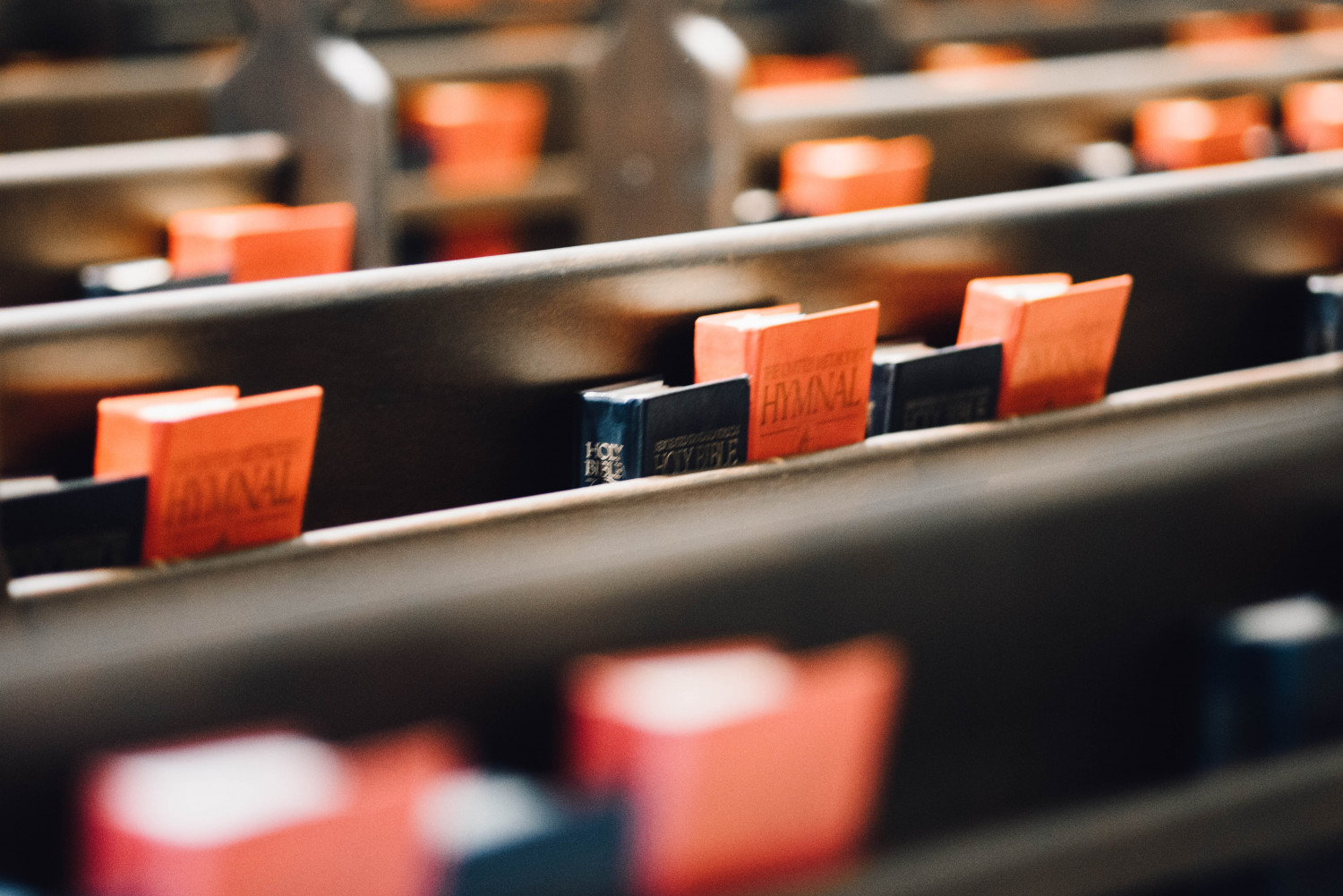 Image of church pews with bibles and psalm books.