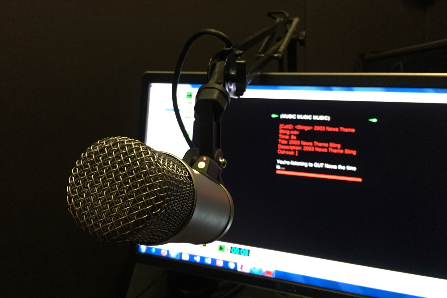 Image of a microphone in front of a screen