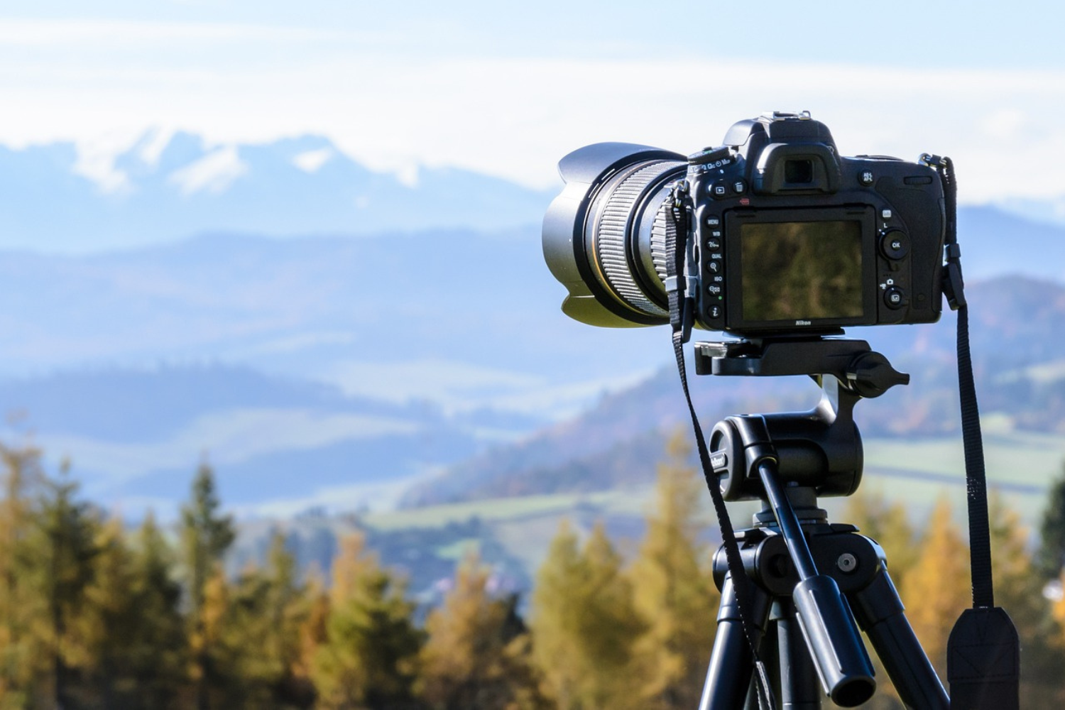 Image of camera on a tripod focussed on countryside